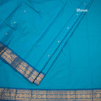 Kanchi Cotton Peacock Blue Saree With Zari Buttas And Zari Border