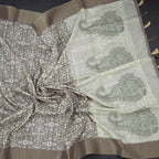 Olive green raw silk saree with printed design and zari border by Shriyara Life, showcasing intricate patterns and elegant draping.