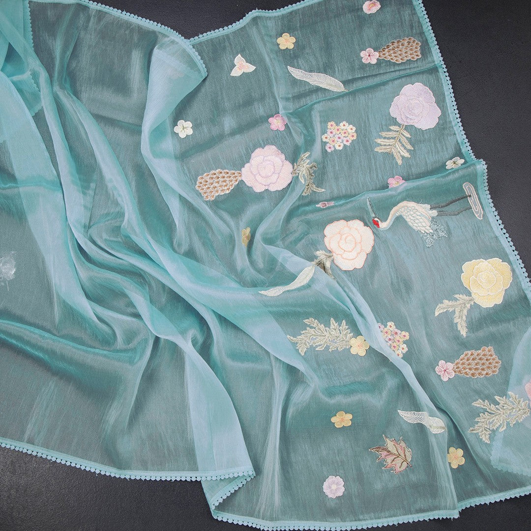 Sky blue soft tissue saree with intricate thread work from Shriyara Life, showcasing elegant draping and detailed craftsmanship.