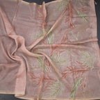 Light peach organza saree with leaf print and zari thread work by Shriyara Life, showcasing intricate embroidery and elegant fabric.
