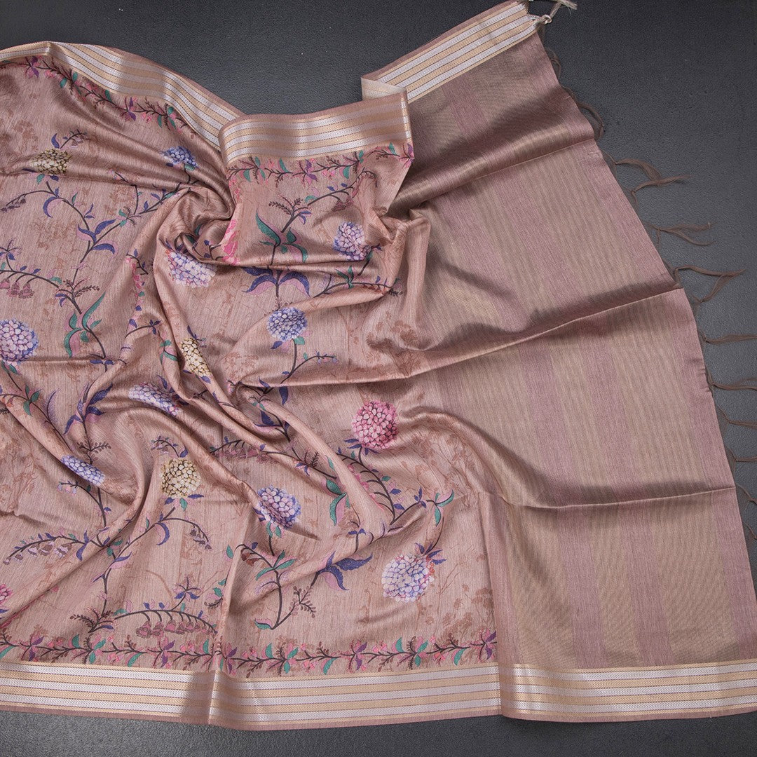 Light brown raw silk saree with floral print and zari border by Shriyara Life, featuring intricate designs and elegant fabric.