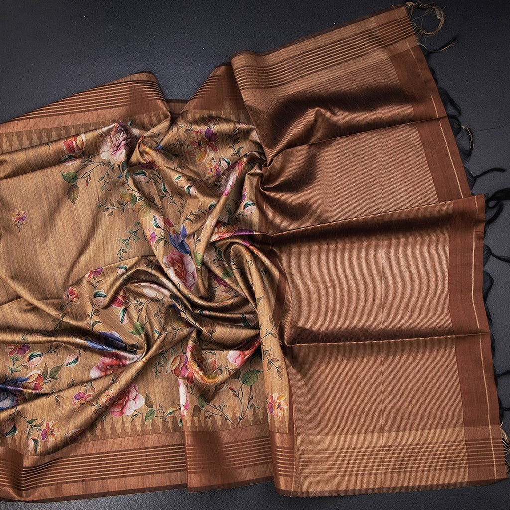 Golden brown raw silk saree with floral print and zari border by Shriyara Life, featuring intricate floral designs and elegant border details.