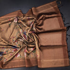 Golden brown raw silk saree with floral print and zari border by Shriyara Life, featuring intricate floral designs and elegant border details.
