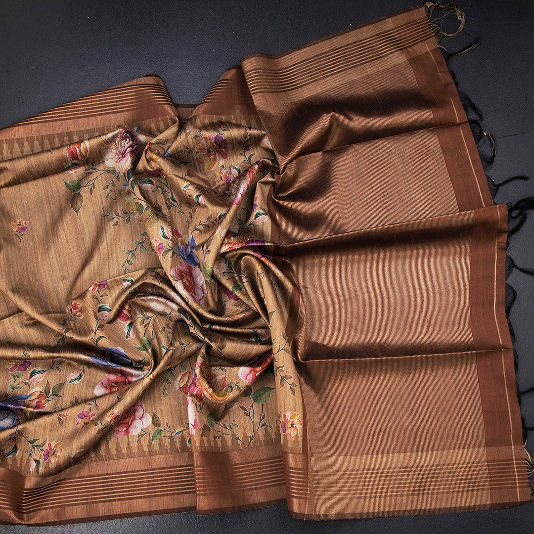 Golden brown raw silk saree with floral print and zari border by Shriyara Life, featuring intricate floral designs and elegant border details.