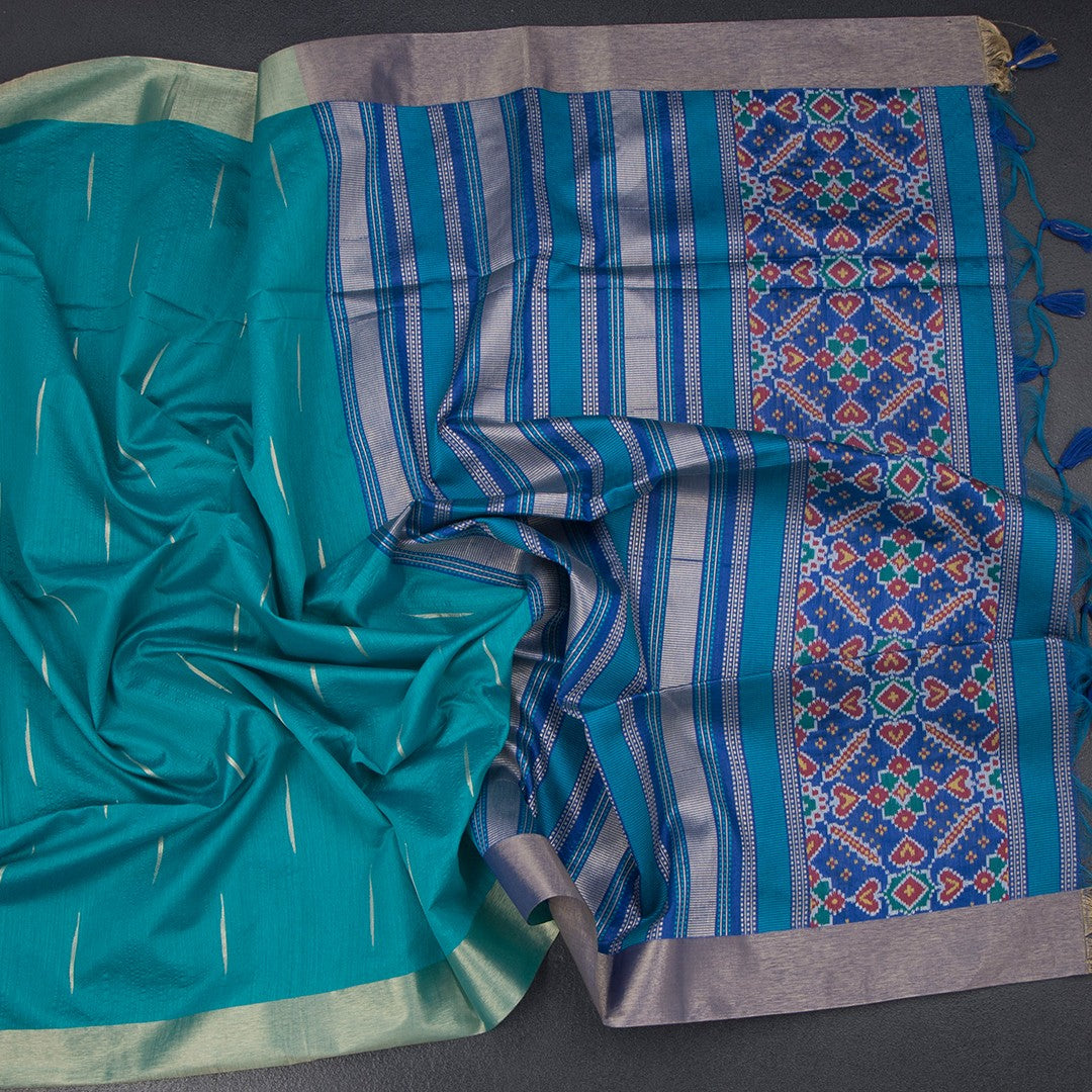 Raw silk peacock green saree with malli moggu design and zari border from Shriyara Life, showcasing intricate patterns and rich fabric.