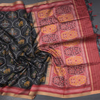 Black raw silk saree with intricate printed design from Shriyara Life, showcasing elegant traditional Indian attire.