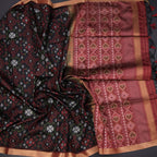 Black raw silk printed saree by Shriyara Life featuring intricate patterns and elegant drape.