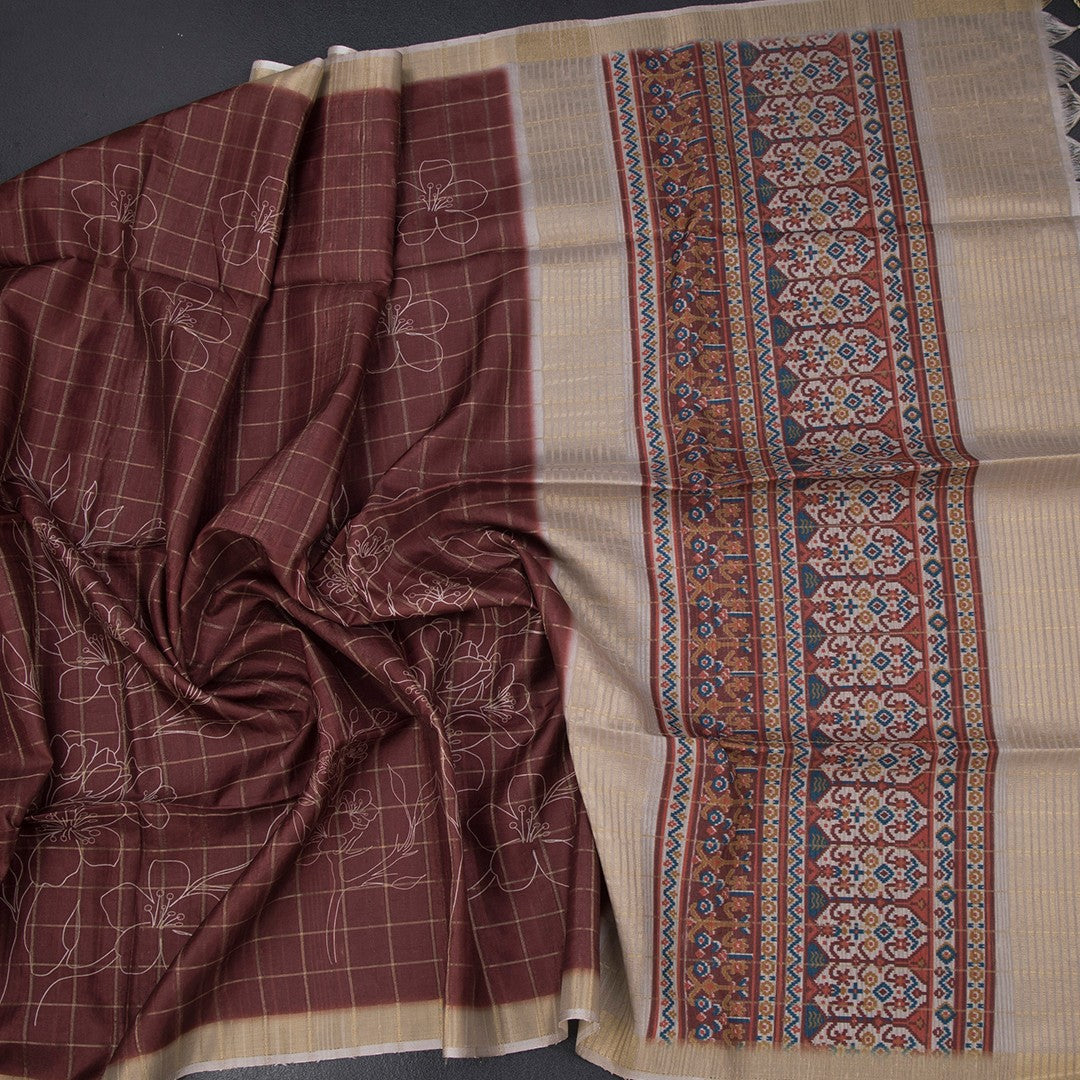 Raw silk maroon checks saree with printed design from Shriyara Life, showcasing intricate patterns and rich fabric details.