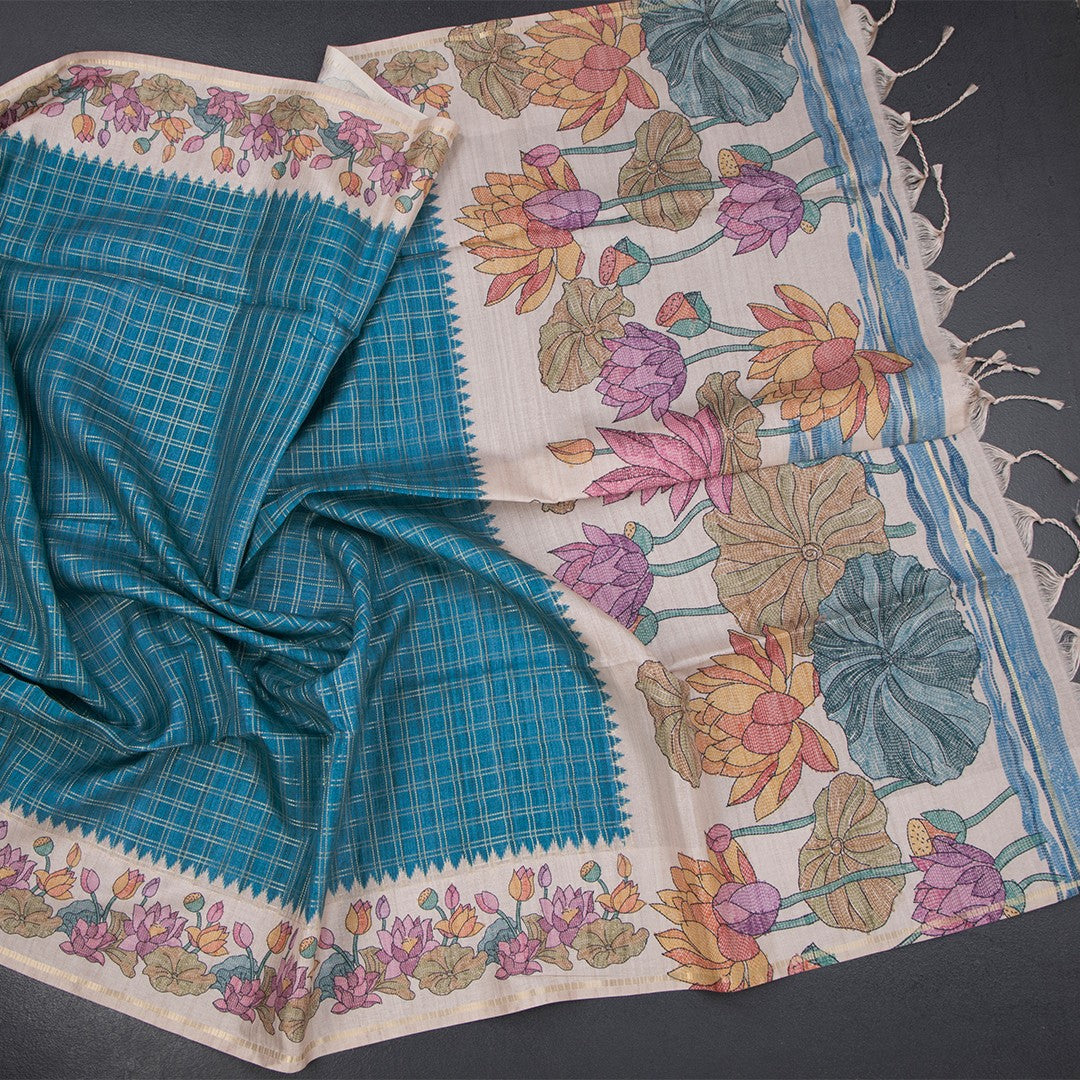 Peacock blue raw silk saree with zari checked pattern from Shriyara Life, showcasing intricate woven design and luxurious fabric.