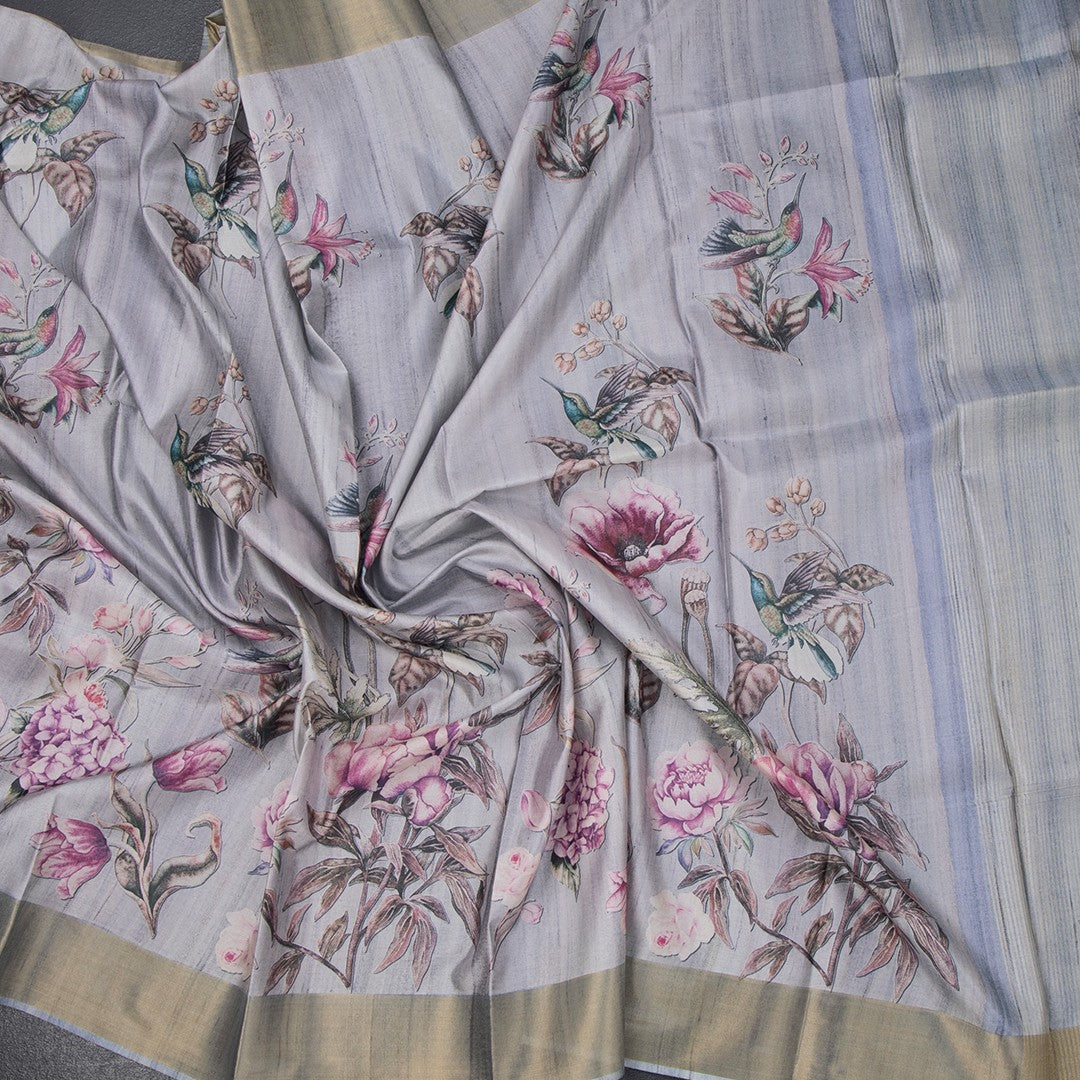 Gray raw silk saree with floral print from Shriyara Life, showcasing intricate floral patterns on soft silk fabric.