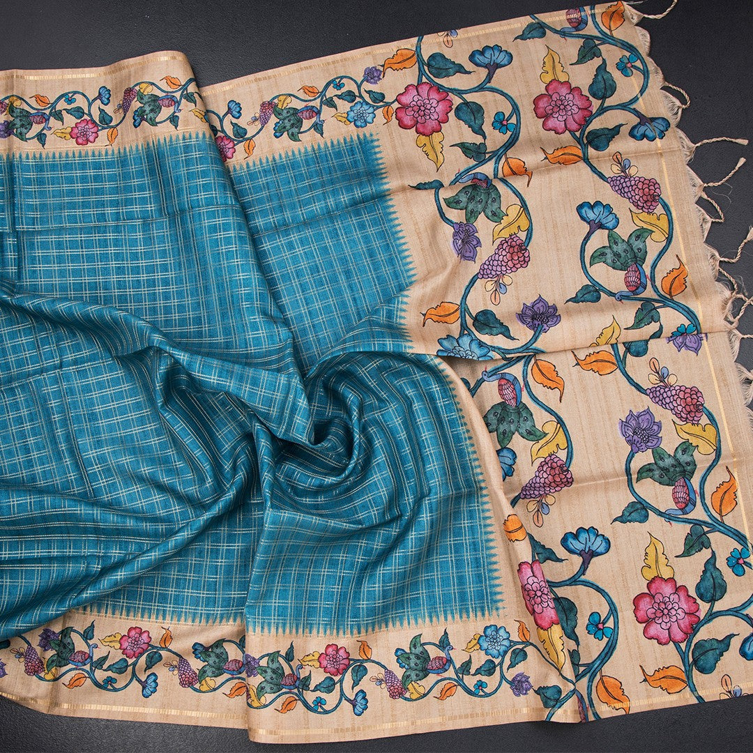 Raw silk peacock blue saree with zari checked pattern from Shriyara Life, showcasing intricate design and luxurious fabric.