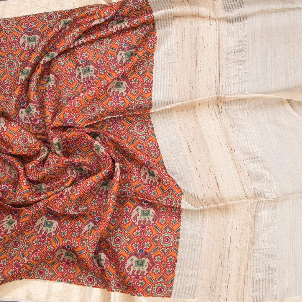 Raw silk orange printed saree from Shriyara Life, featuring traditional floral patterns and elegant drape.