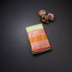 Light Green Self Designed Silk Saree With Orange Border And Gold And Silver Zari Work