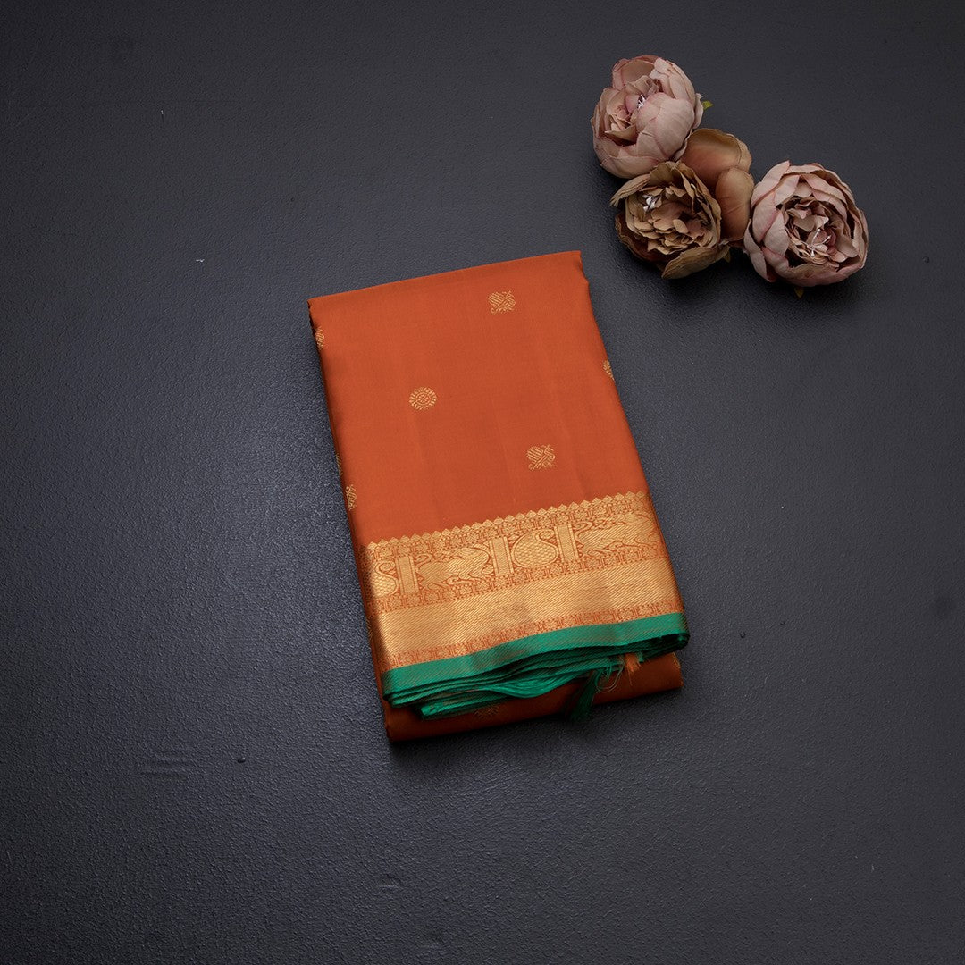 Rust Orange Silk Saree With Peacock And Chakra Buttas And Gold Zari Border