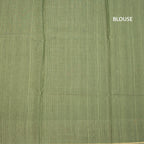 Pista green raw silk saree with zari checked pattern and thread border, paired with matching blouse from Shriyara Life.