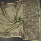 Pista green raw silk saree with zari checked pattern and thread border by Shriyara Life, showcasing intricate design and luxurious fabric.